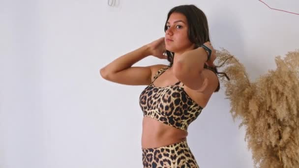 girls pose in a photo studio in swimsuits, advertising them for sale. - Footage, Video