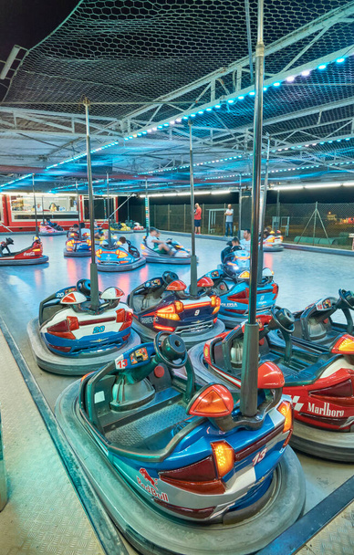 Italy, Sicily, Marina di Ragusa (Ragusa Province); 20 July 2021, kids driving electric bumping cars in an amusement park at night - EDITORIAL - Foto, imagen