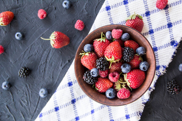 A healthy serving of fresh summer berries. Creative atmospheric decoration - Φωτογραφία, εικόνα
