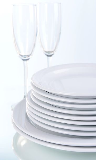 Set of white dishes on table on light background - Fotó, kép