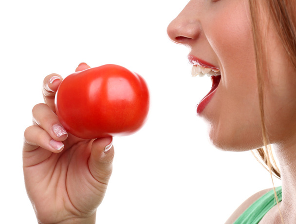 Beautiful girl eating tomato - Valokuva, kuva