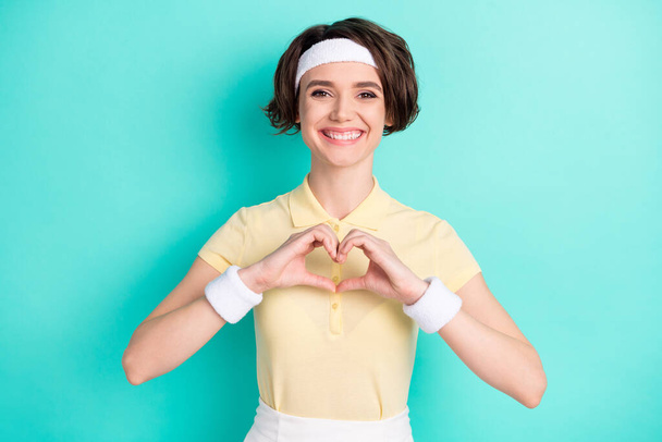 Photo of cheerful charming nice young woman make hands heart smile sport isolated on teal color background - Φωτογραφία, εικόνα