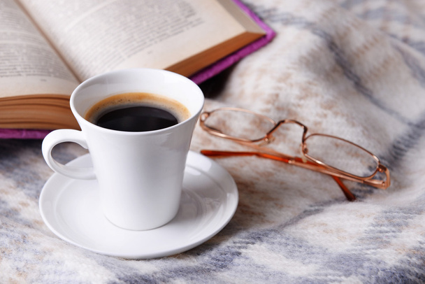Cup of coffee on plaid with book - Fotoğraf, Görsel