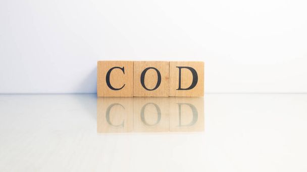 The name Cod was created from wooden letter cubes. Seafood and food. close up. - Zdjęcie, obraz