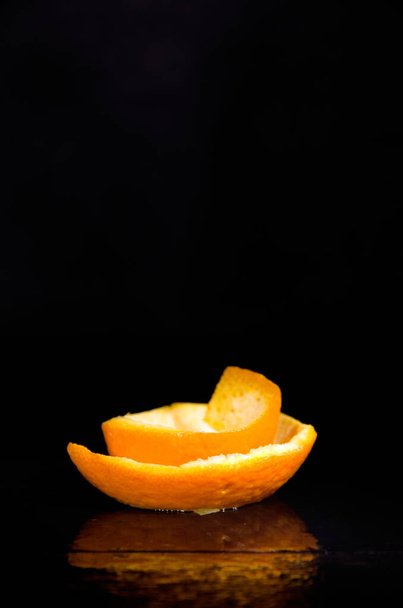 Freshly Cut Orange Peel on Dark Wet Background Vertical - Photo, Image