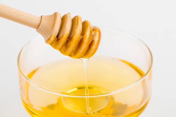 Honey ladle. Honey tidbit in a glass jar. - Photo, Image