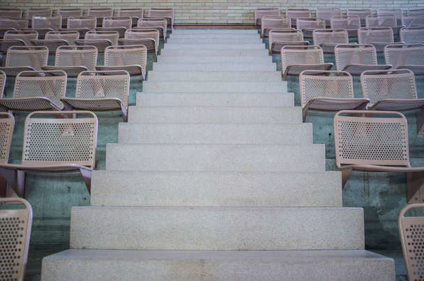 アリーナのグランドスタンドの金属製の席がいっぱいです。コンクリート階段 - 写真・画像