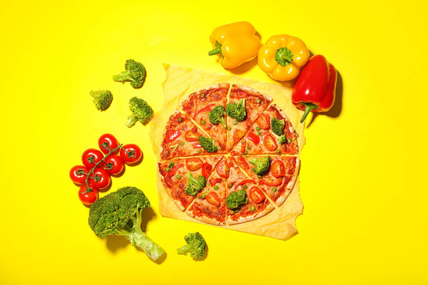 Parchment with tasty vegetarian pizza on color background - Photo, Image
