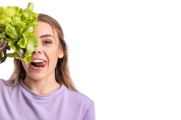 Young woman with fresh lettuce on white background - Fotografie, Obrázek