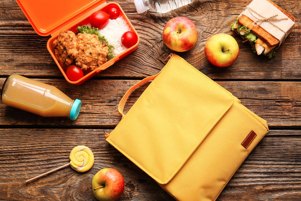 Lunch box bag and food on wooden background - Photo, Image
