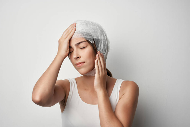 woman holding head bandage injury health medicine - Fotografie, Obrázek