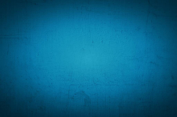 Old blue wall in spots, cracks, stains. Painted concrete wall in abstract grunge style loft. Vintage wall background texture for backgrounds, portraits, posters. - Photo, Image