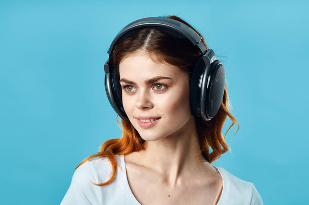 cheerful girl in a white t-shirt wearing headphones joystick technology game - 写真・画像