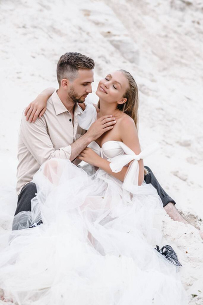 Beautiful wedding couple bride and groom at wedding day outdoors at ocean beach. Happy marriage - Fotografie, Obrázek