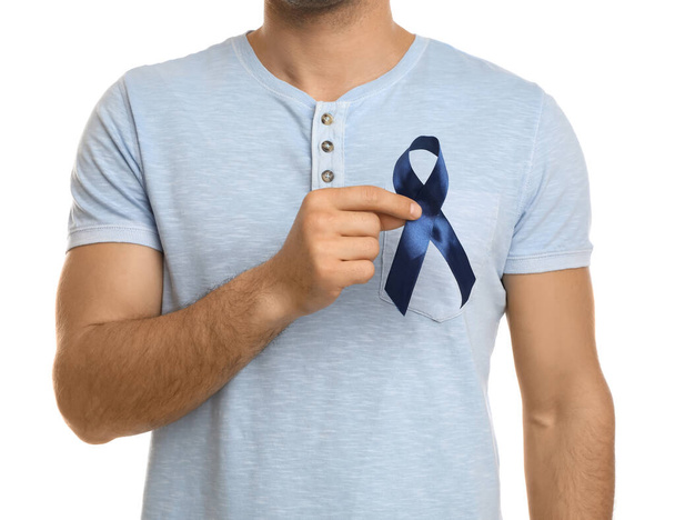 Man with blue ribbon on white background, closeup. Urology cancer awareness - Fotografie, Obrázek
