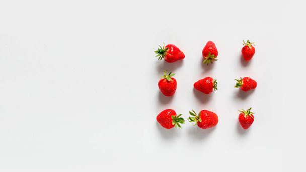 Top view background with organic tasty strawberry berries frame on a white background. Top view. Flat lay. - Foto, Imagen
