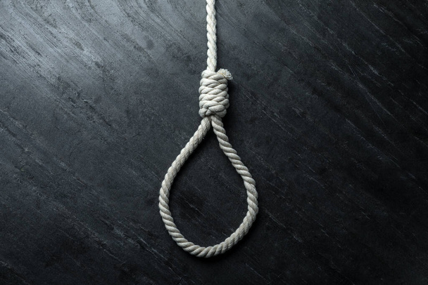 Rope noose on black table, top view - Foto, Imagem