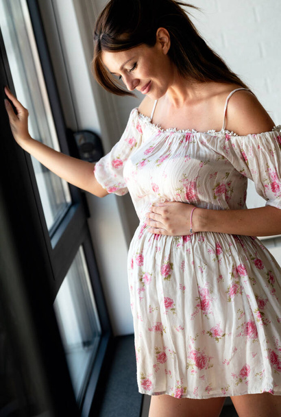 Happy beautiful pregnant woman with big tummy relax at home - Foto, afbeelding
