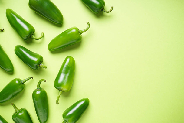 Jalapeno chili peppers, on a green background, place for text. Top view. - Photo, Image