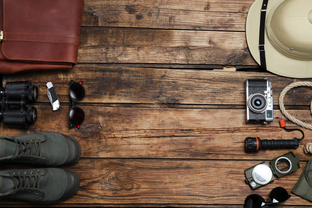 Flat lay composition with different safari accessories on wooden background. Space for text - Foto, Bild