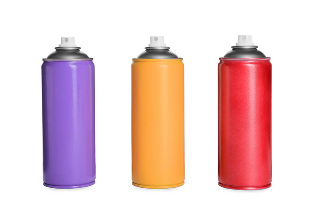Cans of different spray paints on white background. Graffiti supplies - Foto, Bild