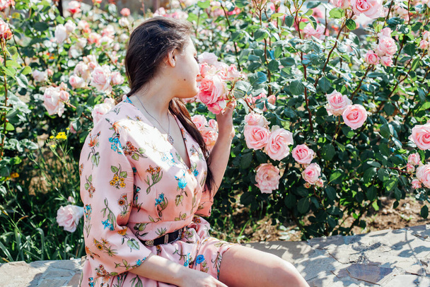 beautiful brunette woman in a dress with flowers portrait - Valokuva, kuva