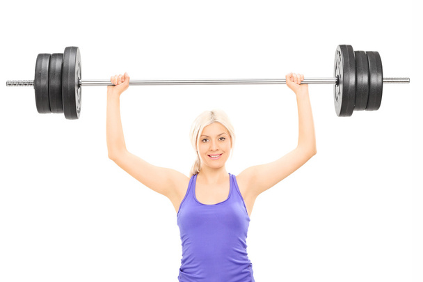 Female athlete lifting heavy barbell - Foto, imagen