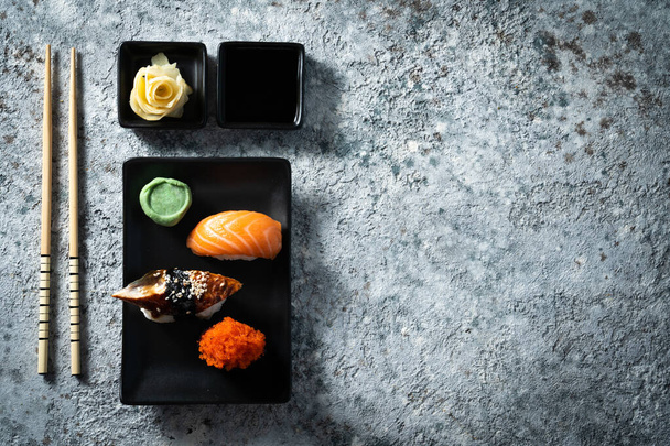 Selection of sushi on rustic background, copy space - Foto, afbeelding