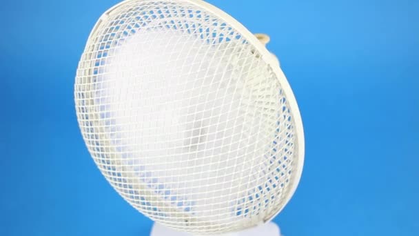 rotating retro fan ventilator on blue screen background, vintage electrical conditioning and air cooling,  front upper view - Footage, Video