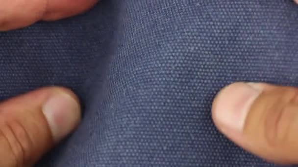 qualità dei test a mano umana di tessuto di tela cerata blu materiale tessile, vista da vicino - Filmati, video