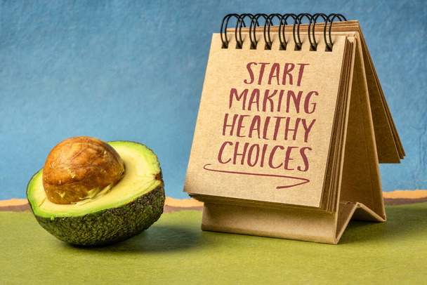 start making healthy choices motivational reminder - handwriting in a desktop calendar with avocado, lifestyle and personal development concept - Фото, изображение