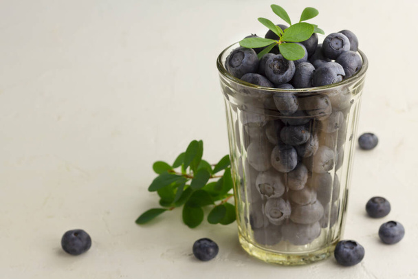 Fresh blueberries in a glass on light background - Photo, image