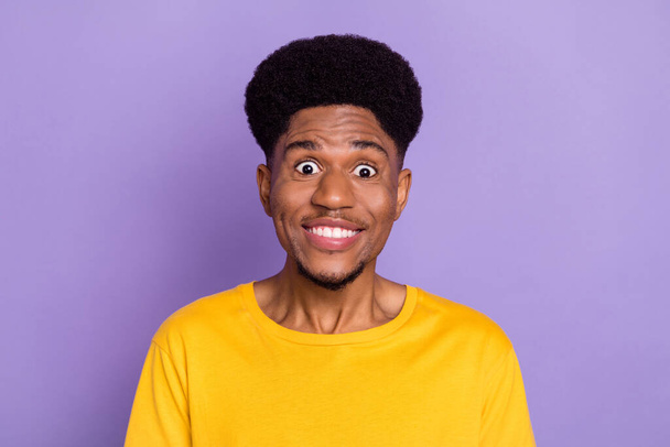Portrait of attractive cheerful guy candid smile good mood news staring eyes isolated over violet purple color background - Foto, Imagem