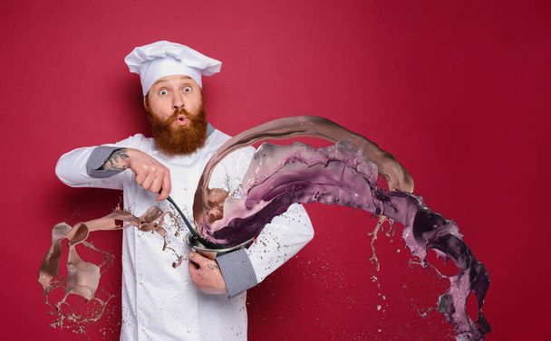 Chef is surprised about a new recipe. burgundy background - Photo, Image