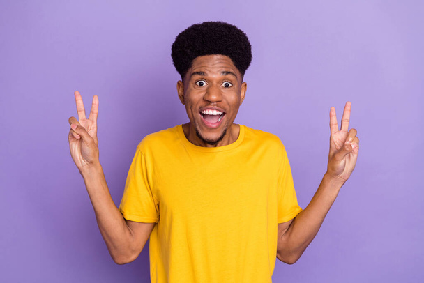 Portrait of attractive funny cheerful cool guy showing double v-sign good mood isolated over violet purple color background - Valokuva, kuva