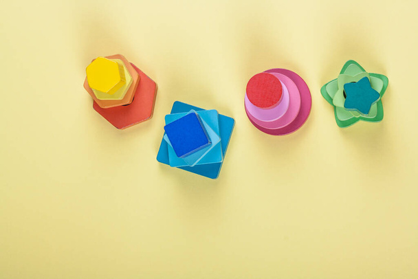 Wooden multicolored geometric shapes for children on a solid background - Fotografie, Obrázek