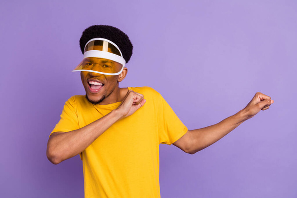 Portrait of attractive funky cheerful guy wearing sun hat having fun dancing isolated over violet purple color background - Fotoğraf, Görsel