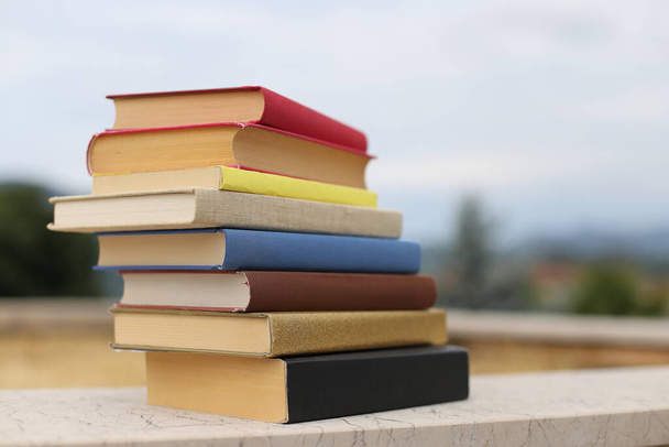 Stack of books on the wall in front of the school - Photo, Image