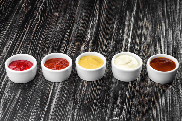 assorted sauces on a dark wooden background - Photo, Image