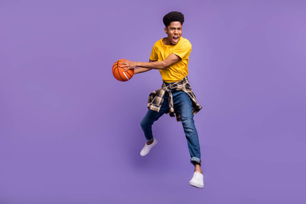 Full length body size view of attractive energetic motivated guy jumping playing game isolated over violet purple color background - Foto, Imagen