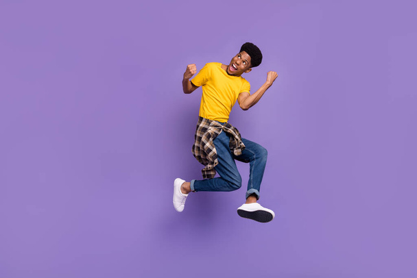 Full length body size view of attractive cheerful successful guy jumping celebrating isolated over violet purple color background - Valokuva, kuva