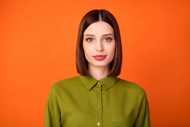 Photo of nice brunette hairdo young lady wear khaki shirt isolated on orange color background - Fotoğraf, Görsel