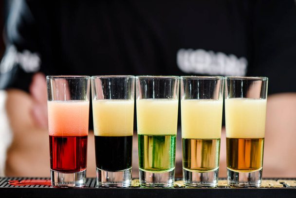 Colorful cocktails shots in the bar. Strong alcoholic drinks and tequila - Photo, Image