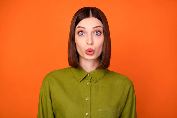 Photo of impressed brunette hairdo young lady wear khaki shirt isolated on orange color background - Foto, immagini