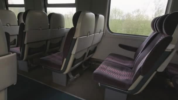 Empty seats in train with Vilnius tower view through window. Lithuania public railway transport concept. - Footage, Video