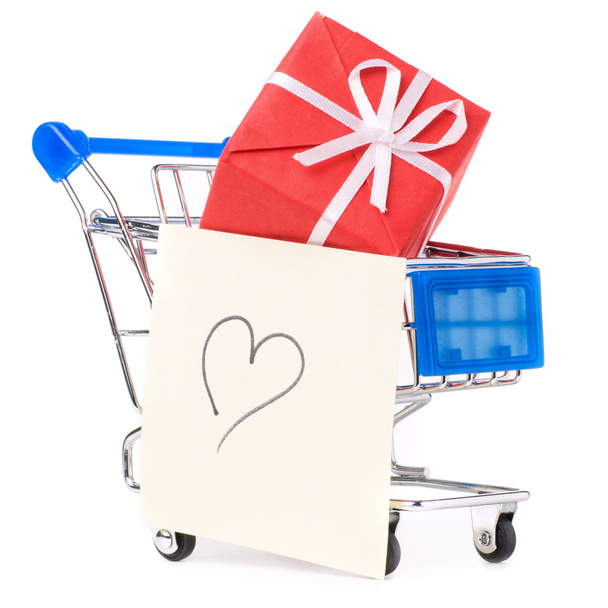 Closeup of a shopping cart with gifts and heart - 写真・画像