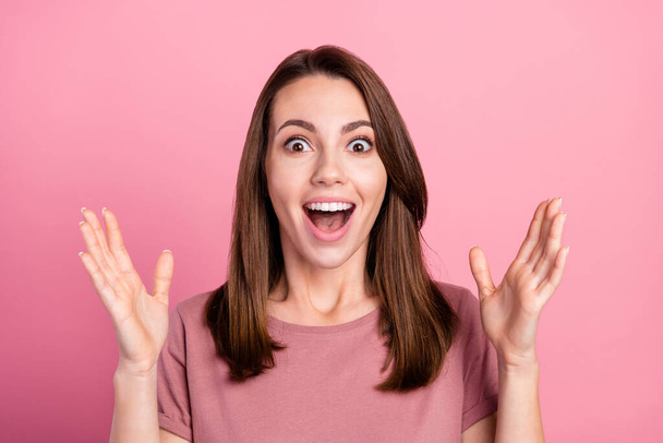 Photo of young attractive woman amazed shocked surprised omg wow sale isolated over pink color background - Foto, afbeelding