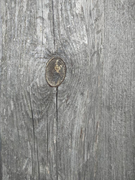  texture of an old wooden board with a knot blackened in the sun  - Photo, Image