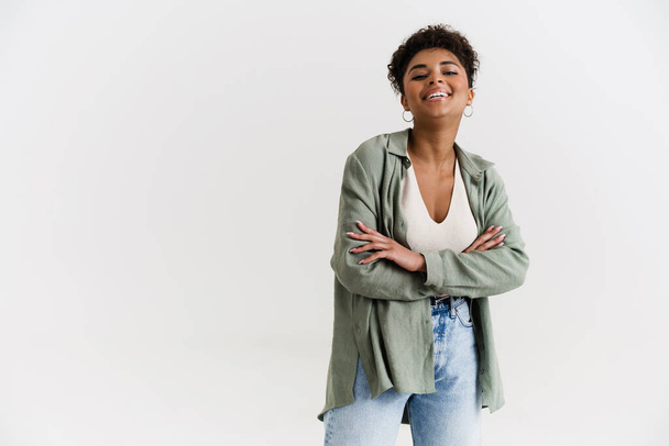 Young black woman in shirt laughing and looking at camera isolated over white background - Zdjęcie, obraz