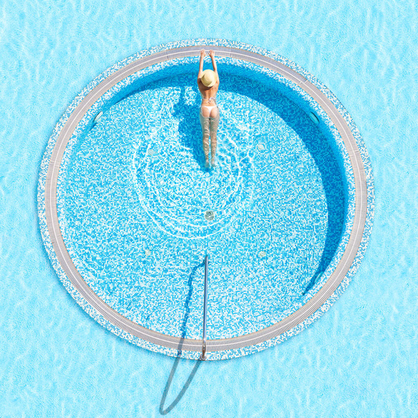 Young alone beautiful sports woman in bikini and hat is swimming in jacuzzi. Aerial drone view from above. Tropical summer luxury hotel - Fotografie, Obrázek